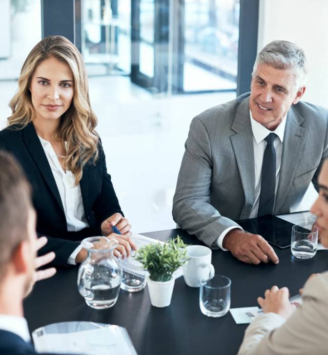 High angle shot of a group of businesspeople sitting in the boardroom during a meeting